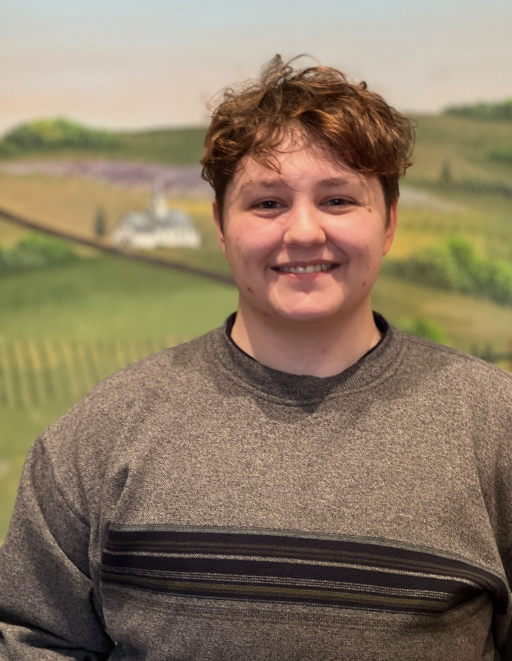 Alyx Smiling in front of Stevens County Mural